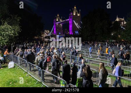 Mourners continue to queue in the night along River Thames southbank to see Queen Elizabeth II lie in state in Westminster Hall.   Pictured: Snake que Stock Photo