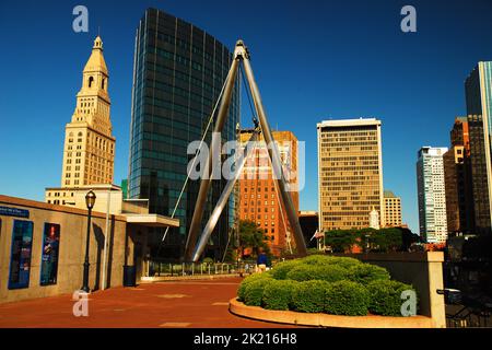 The skyline or Hartford Connecticut, as seen from the Founders Bridge, a pedestrian walkway, contains a mix of modern and classic architecture Stock Photo