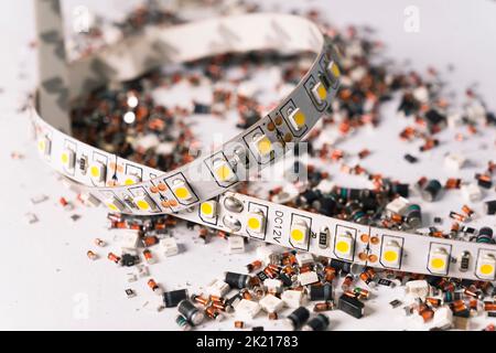 Electricity in modern world concept. Abstract closeup of various colourful scattered electronic parts over white background. Focus on the foreground. High quality photo Stock Photo