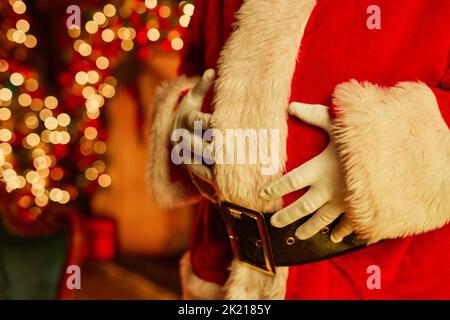 Christmas background image with unrecognizable Santa Claus wearing red suit, copy space