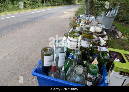 containers of glass bottles by roadside awaiting collection Stock Photo