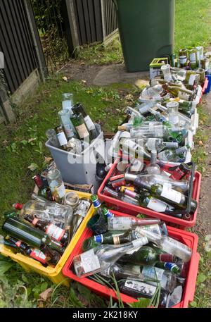 containers of glass bottles by roadside awaiting collection Stock Photo