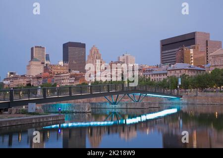 Montreal Skyline and footbridge reflected in Bonsecours Basin at dawn in spring, Old Port of Montreal, Quebec, Canada. Stock Photo