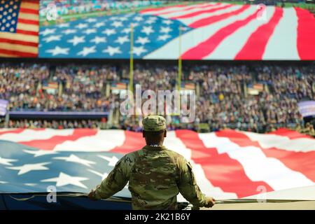 Baltimore, Maryland, USA. 18th Sep, 2022. Maryland National Guard soldiers and airmen participate in the pre-game ceremony for the Baltimore Ravens against the Miami Dolphins game at M&T Bank Stadium in Baltimore, Md., Septembert. 18, 2022. The pre-game ceremony included service members holding a large American flag at mid-field during the national anthem. Credit: U.S. Army/ZUMA Press Wire Service/ZUMAPRESS.com/Alamy Live News Stock Photo