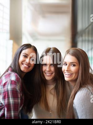 Friends make university fun. Portrait of three female university students on campus. Stock Photo