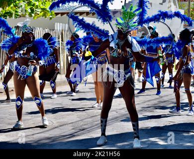 Beautifully costumed dancers having fun in the San Pedro, Belize, Carnival parade. The costumes are in blue with white details and shiny beads. Stock Photo