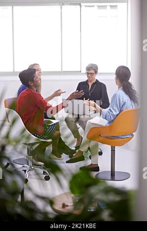 Coming up with a winning strategy. a group of female designers sitting in a creative meeting. Stock Photo