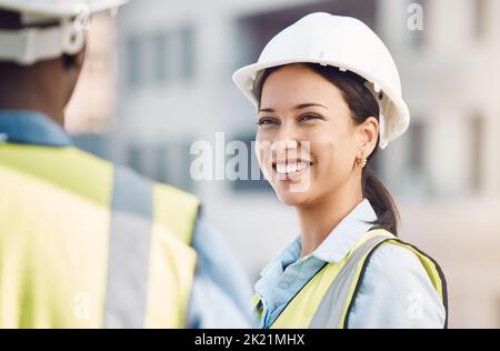 Building engineer, construction worker or engineering woman with smile, motivation or property vision for real estate architecture. Happy development Stock Photo