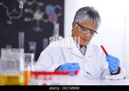 Research that will save lives. A senior female scientist working in her lab. Stock Photo