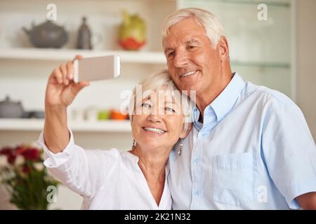 Getting the hang of this selfie thing. a senior couple taking a selfie with their cellphone. Stock Photo