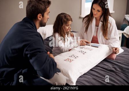 House of cards. a young family playing cards together at home. Stock Photo