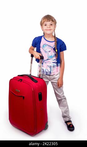 Travel. Journey. Tourism. Cute little girl and big red suitcase isolated on white background