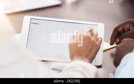 Hands, tablet and data of an analyst or employee in digital file management app at the office. Hand of business people working with touchscreen Stock Photo