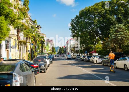 BATUMI, GEORGIA - 4th august, 2022: car parked side of road in city center in sunny summer day. Vehicles in traffic in Batumi resort in peak season Stock Photo