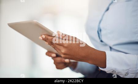 Hands of business woman working on a tablet analyzing annual company data or information for marketing campaign. Professional black girl with digital Stock Photo