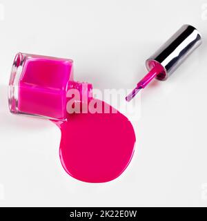Dont cry over spilt varnish. Studio shot of bottle lying sideways spilling out nail varnish. Stock Photo