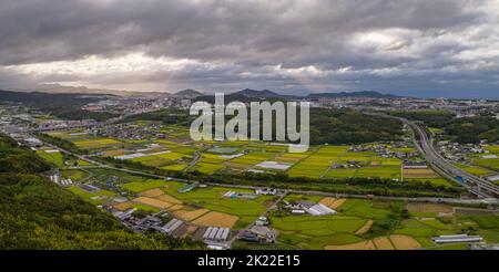 Panoramic aerial view of shafts of light breaking through storm clouds over farmland Stock Photo