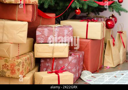 Christmas gifts on the floor under the tree Stock Photo