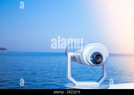 Tourist binoculars. Binocular telescope on the observation deck for tourism. Sea background. Binoculars watching at horizon at ship deck. Travel tourist destination attraction. Copy space for text. Sopot on the pier Stock Photo