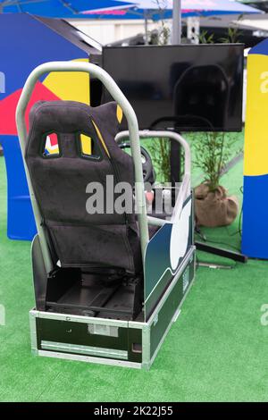 Professional Gaming Seat with Steering Wheel, Pedals and Screen for driving Simulator Video Game. Stock Photo