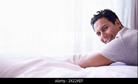 We all need some time off every now and again. Portrait of a handsome young man relaxing at home. Stock Photo