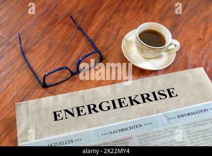 Energy crisis newspaper with glasses and coffee on a desk Stock Photo