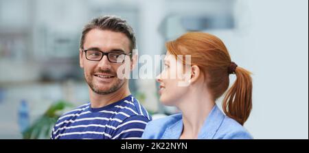 Im so glad were partners. two coworkers in an office setting. Stock Photo