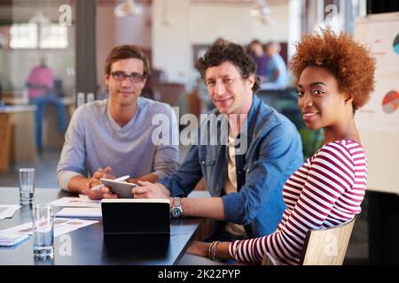 The project is looking great. a group of colleagues collaborating with each other on a project in an office. Stock Photo