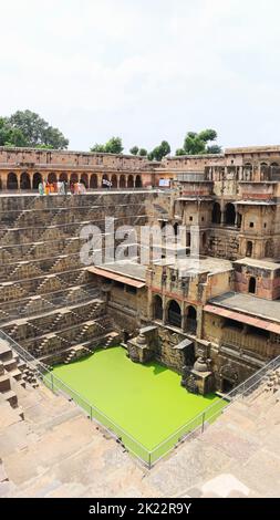 INDIA, RAJASTHAN, DAUSA, July 2022, Tourist at Chand Baori stepwell  water and  stone steps, Abhaneri Stock Photo