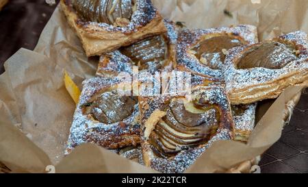 close-up of caramel, apple puff pastry cakes. Latvian rural market. Stock Photo