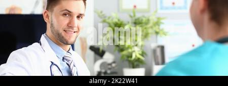 Two doctors discussing the medical diagnosis of patient Stock Photo