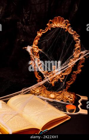 Halloween book composition, spider web, old vintage frame on a black background Stock Photo