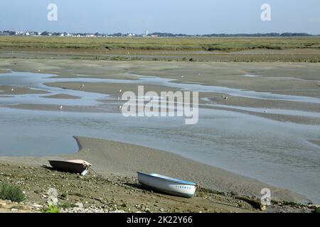 View of Baie de Somme and boat at low tide with Le Crotoy in the distance from Quai Digne Nord, Saint Valery sur Somme, Somme, Picardy, Hauts de Franc Stock Photo