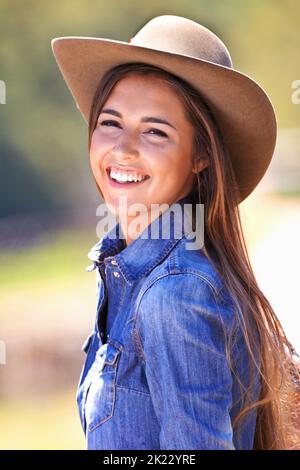 Howdy, partner. Cropped image of a young cowgirl outside in the sun. Stock Photo