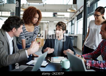 Getting a head start on the project. office workers talking in a meeting in an office. Stock Photo