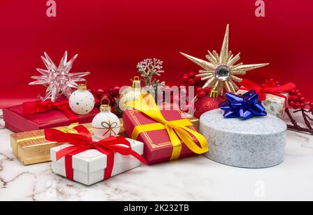 Christmas gift boxes isolated on marble table and red background Stock Photo