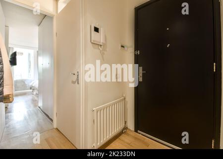 Interior of small corridor with telephone and radiator Stock Photo