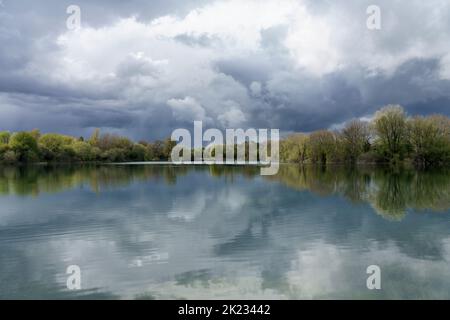 A view across the lake at the Neigh Bridge Country Park, one of the many lakes that make up the Cotswold Water Park Stock Photo