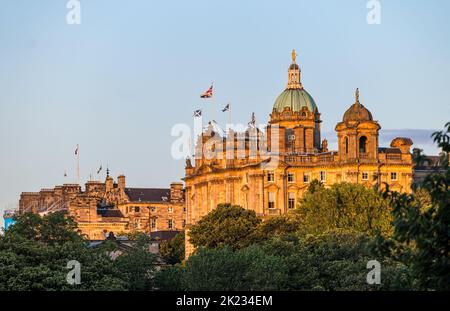 Grand building with copper dome former Bank of Scotland headquarters  flying saltire and Union Jack national flags, Edinburgh, Scotland, UK Stock Photo