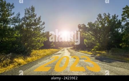 Happy New Year 2023 anniversary. Transition from 2022 to new year 2023 on road. High resolution photo for large displays, print, banners, social media. Stock Photo