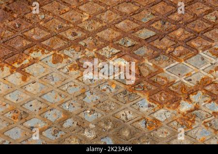 Industrial old rust metal steel sheet with rhombus shapes or checkered plates. Rusty metal background with two horizontal shadows Stock Photo