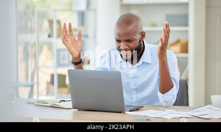 Stressed, upset and frustrated black businessman on a work conference call on a laptop. Angry, African and corporate manager with company documents on Stock Photo