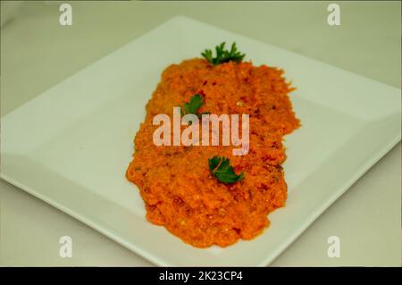 Square white plate with vegetable pisto, a typical vegetable stew from Spain Stock Photo