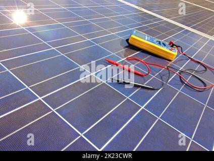 Meter on solar panels with sunshine Stock Photo