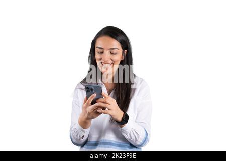 Looking smartphone, portrait of attractive cheerful woman looking smartphone. Isolated over white background. Smiling young beautiful girl amazed. Stock Photo