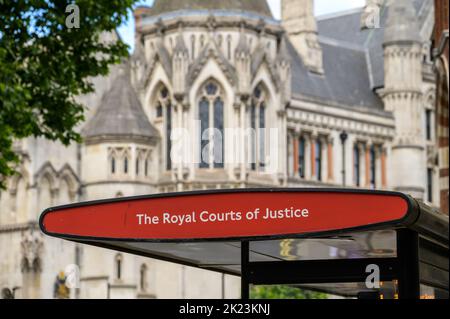 Royal Courts of Justice bus stop sign. Court buildings out of focus in background Stock Photo