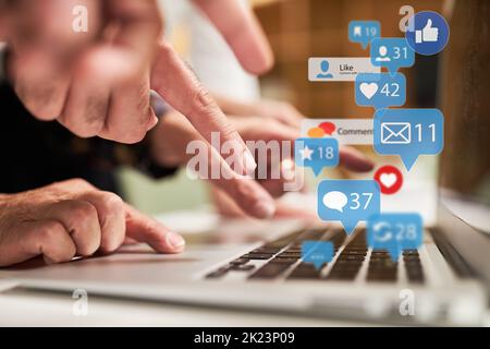 Finger typing on keyboard on laptop computer with many news icons as social media concept Stock Photo