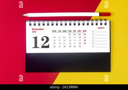 December 2022 Monthly desk calendar for 2022 year with white pencil on beautiful background. Stock Photo