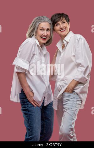 Two well-dressed women looking enjoyed and having fun Stock Photo