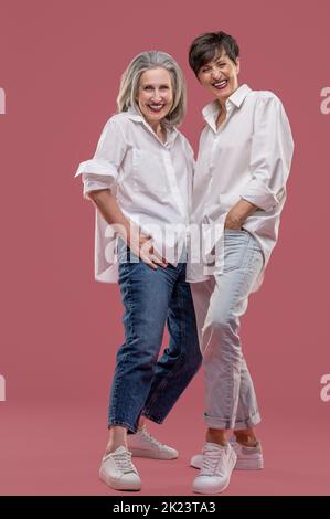 Two well-dressed women looking enjoyed and having fun Stock Photo